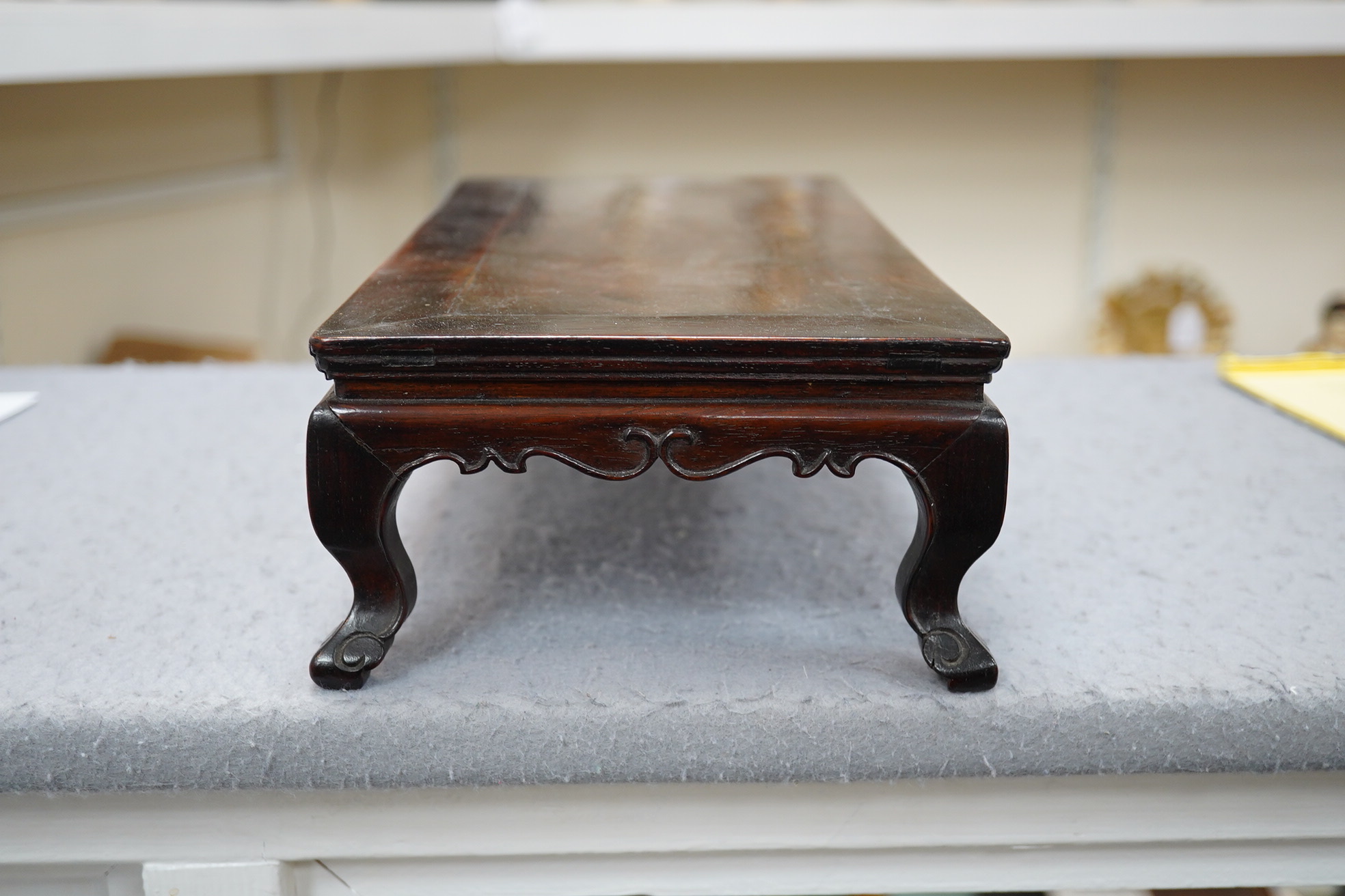 A Chinese huanghuali scholar’s stand, 18th/19th century, and a small reticulated zitan stand, 19th century